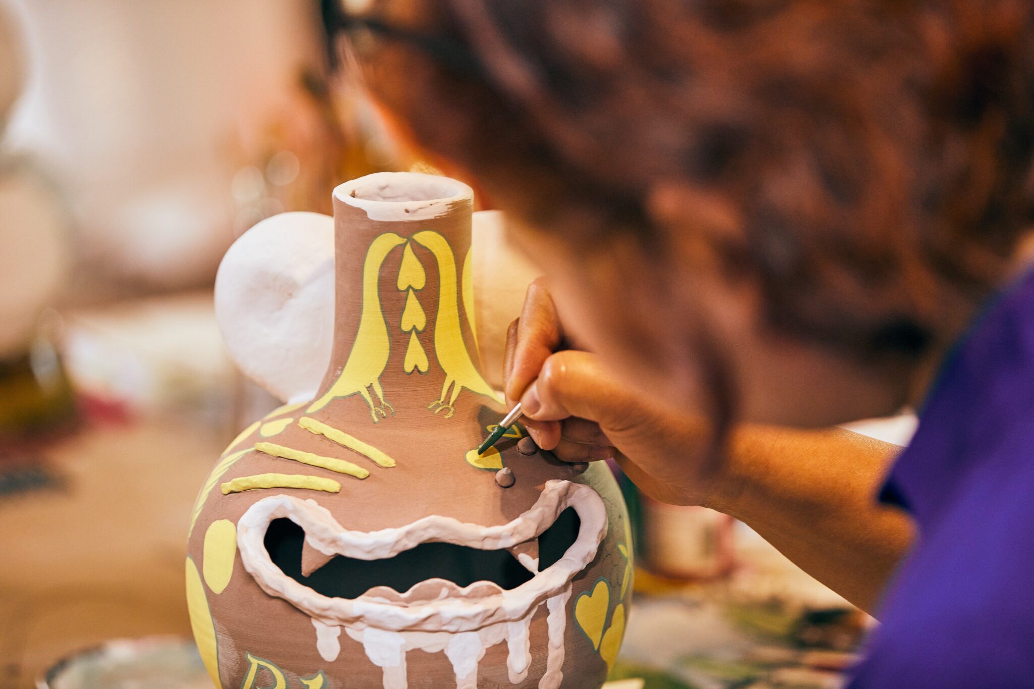 Jiha Moon glazes a ceramic piece Ari Skin Photos