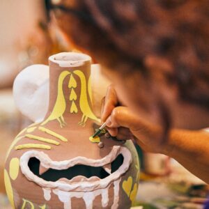 Jiha Moon glazes a ceramic piece Ari Skin Photos