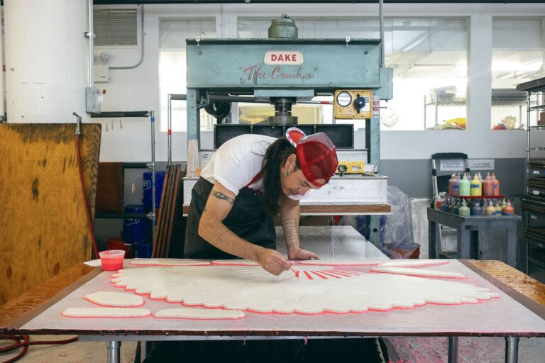 Artist Cannupa Hanska Luger applies pulp paint through a stencil. Melody Melamed