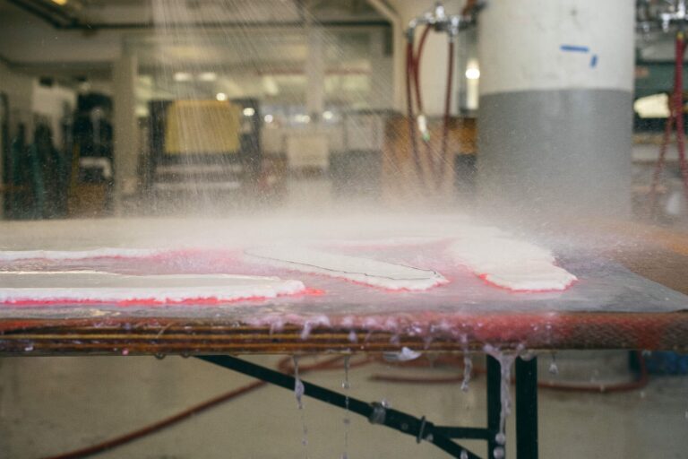 Cannupa Hanska Luger's work being "blown out" - a stencil protects part of the freshly formed sheet of paper while the rest is removed via water pressure. Melody Melamed