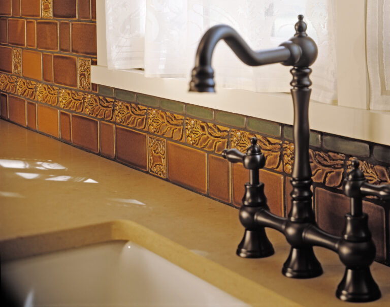 Arts and Crafts kitchen featuring Motawi Tileworks’ animal relief tiles and Leaves & Berries Border. Justin Maconochie