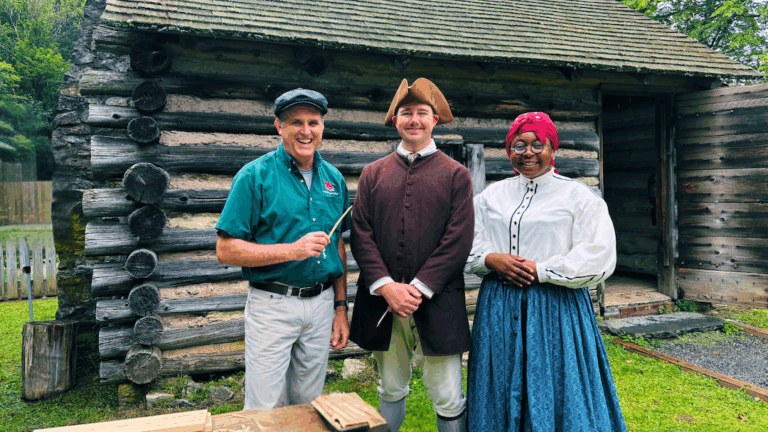 Education Program Volunteers in front of the reproduction log cabin. Red Mill Museum Village