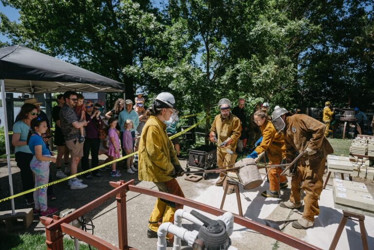 Casting artists pouring molten metal into molds at a free Family Fun Day for the community. Metal Museum