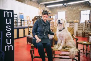 Brandy Clements, 4th Generation Chair Weaver with Rosie at the woven chair museum. Nathan Rivers Chesky