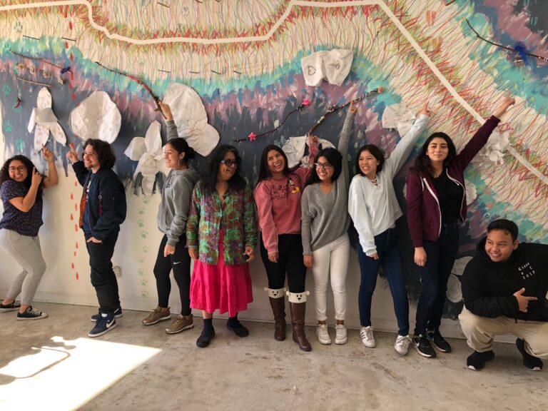Exhibiting artist Consuelo Jimenez Underwood rejoices with local high school students over a collectively-created installation while visiting the Craft Center via our Craft in Schools field trip program. Craft in America