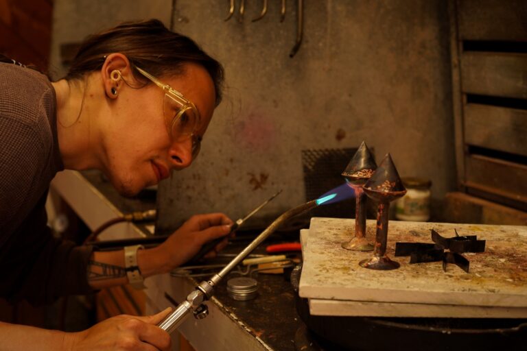 A participant uses a torch in the metals studio. Photo by Dan Rajter. Image courtesy of Haystack Mountain School of Crafts.