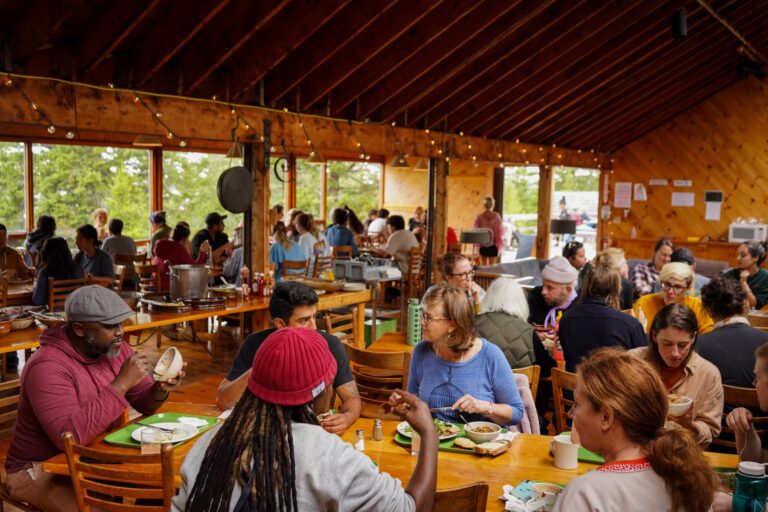 Participants, faculty, and staff enjoy a meal in the dining hall. Photo by Dan Rajter. Image courtesy of Haystack Mountain School of Crafts.