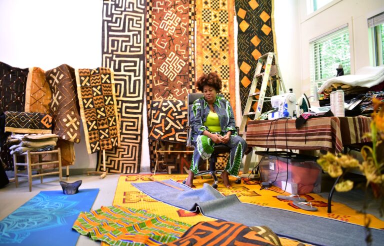 Aishah Hyman surrounded by fabrics during her residency in Fisher Studio. Lauryn Lawrence