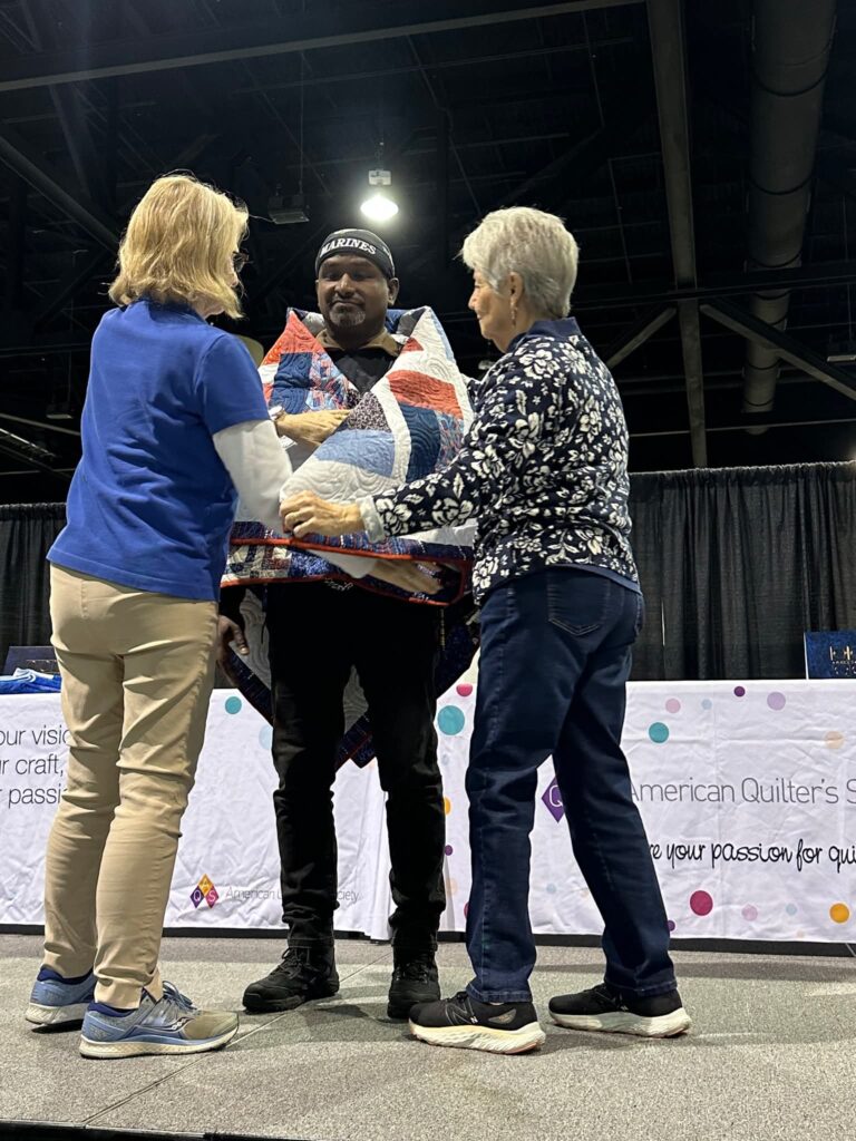 MSgt Michael B. receives his Quilt of Valor in Daytona, FL in 2025. Quilts of Valor Foundation marketing