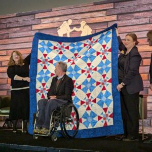Dr. Rory Cooper receives his Quilt of Valor at the AUSA meeting in Washington D.C. in 2024. Kimberly Millay