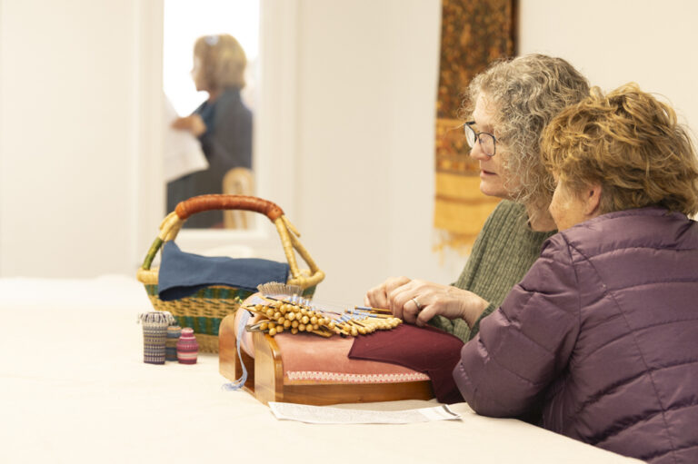 Tammy demonstrating bobbin lace making. Photo by Max Woltman