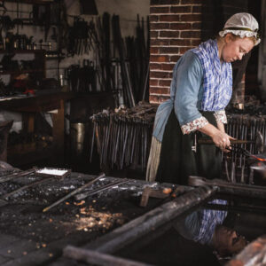 Journeywoman in the Anderson Blacksmith & Armoury in the Historic Area of Colonial Williamsburg. The Colonial Williamsburg Foundation
