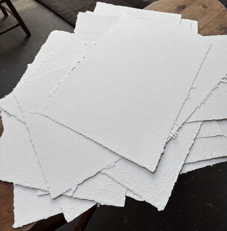 A messy pile of off white handmade paper. Pam DeLuco