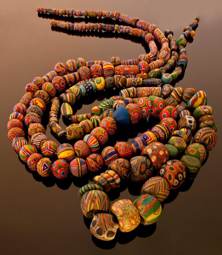 KIFFA AND ISLAMIC GLASS BEADS from Mauritania. Kiffas or Muraqad are unique, wet-inlay powderglass beads made by Mauritanian women. The largest bead shown is an Islamic glass bead, a morfia, 2.3 x 1.9 centimeters. Courtesy of Thomas Stricker collection. Photograph by Alex and Thomas Stricker.