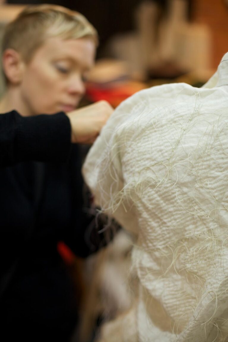 CLOTHING ARTIST AMY NGUYEN with studio assistant Nikki Fleury working on the placement of nui shibori stitching, 2015. Photograph by Mario Avila