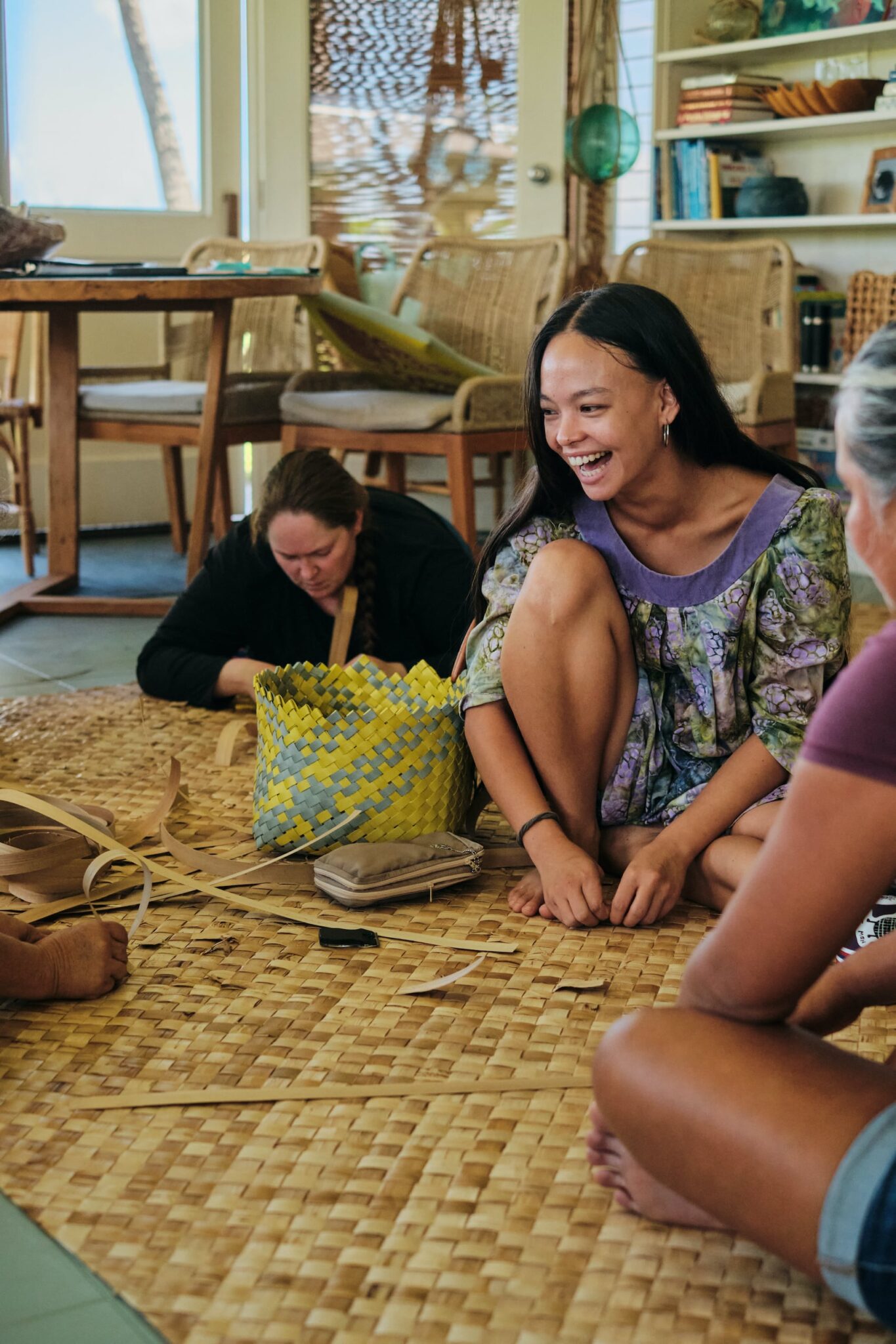 Keanahala weaver Lise Michelle Sugitan Childers repairing a moena lauhala (pandanus leaf mat). Blake Abes