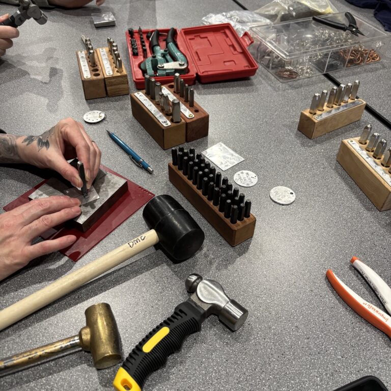 Students during a metal stamping workshop. James Thurman