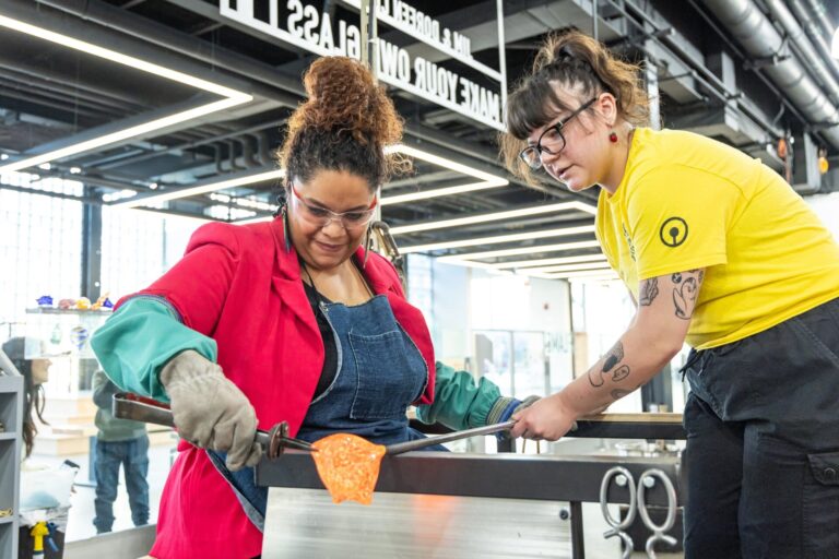A Studio guest makes their own glass flower during a glassmaking experience. Courtesy of Corning Museum of Glass. A Studio guest makes their own glass flower during a glassmaking experience. Courtesy of Corning Museum of Glass.