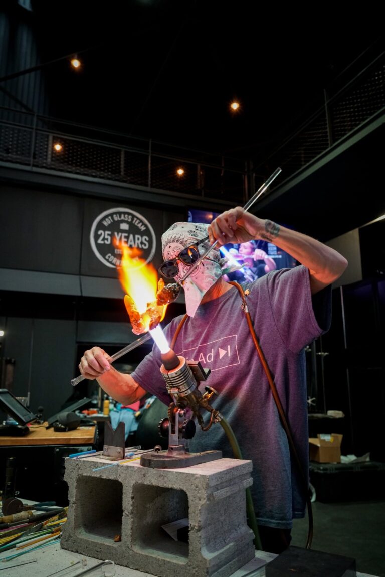 A glass artist creates an intricate flameworked form during a live demonstration. Courtesy of Corning Museum of Glass