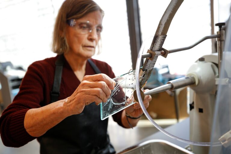 A Studio guest engraves a custom design during an engraving/printmaking experience. Courtesy of Corning Museum of Glass. A Studio guest engraves a custom design during an engraving/printmaking experience. Courtesy of Corning Museum of Glass.