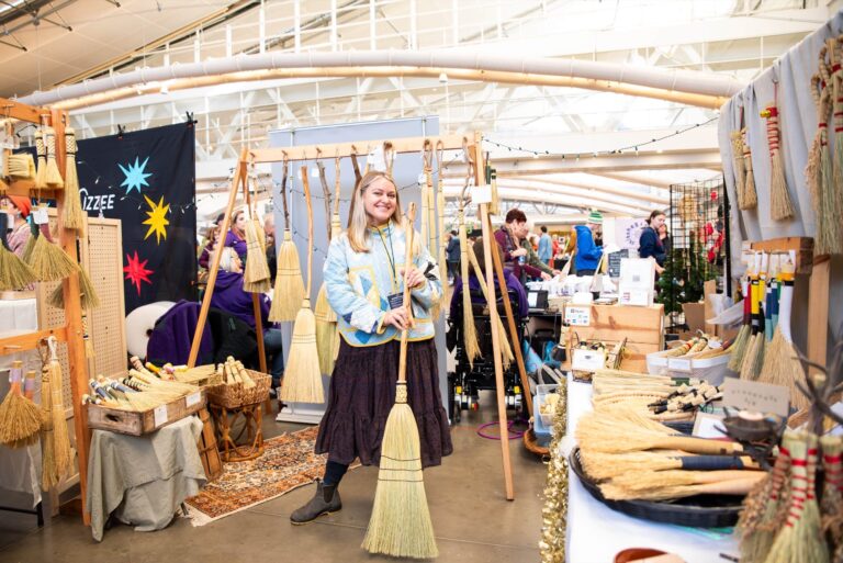 Pittsburgh-based maker Tia Tumminello with her Husk Brooms products and booth at Handmade Arcade’s 2024 Holiday Market. Maker Pictured: Husk Brooms (Photo Credit: Kitoko Chargois, courtesy of Handmade Arcade) Pittsburgh-based maker Tia Tumminello with her Husk Brooms products and booth at Handmade Arcade's 2024 Holiday Market. Maker Pictured: Husk Brooms (Photo Credit: Kitoko Chargois, courtesy of Handmade Arcade)