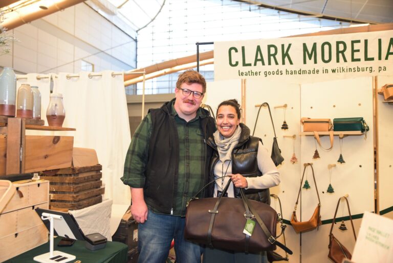 Pittsburgh-based makers Rob Hackett and Jocelyn Avila with their Clark Morelia products and booth at Handmade Arcade’s 2024 Holiday Market. Maker Pictured: Clark Morelia (Photo Credit: Kitoko Chargois, courtesy of Handmade Arcade) Pittsburgh-based makers Rob Hackett and Jocelyn Avila with their Clark Morelia products and booth at Handmade Arcade's 2024 Holiday Market. Maker Pictured: Clark Morelia (Photo Credit: Kitoko Chargois, courtesy of Handmade Arcade)