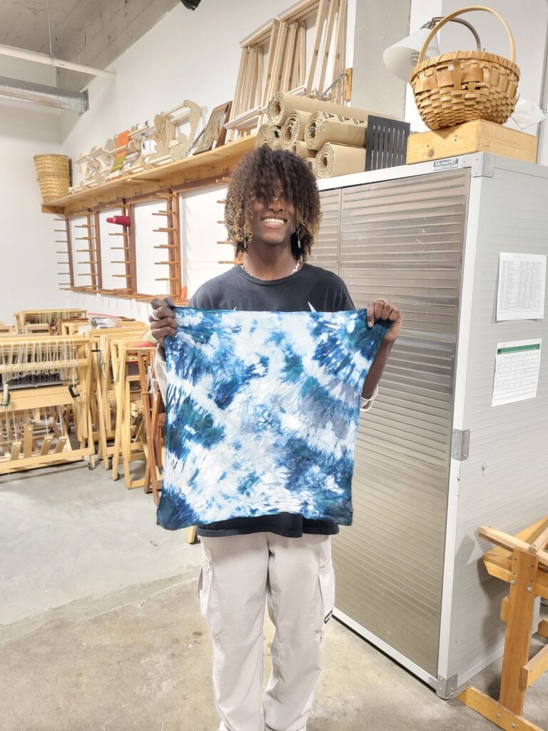 Crossroads High School student with shibori indigo piece. Danielle Lee