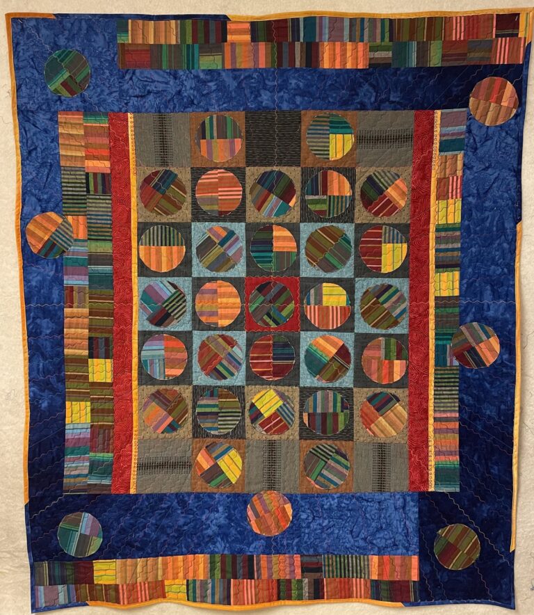 “Colours of You” (inspired by the Netflix show Heartstopper) by Joni Seidenstein. This 48″ x 58″ piece is made with cotton fabrics and thread. Celebrates individual expression in a supportive community. Joni Seidenstein "Colours of You" (inspired by the Netflix show Heartstopper) by Joni Seidenstein. This 48" x 58" piece is made with cotton fabrics and thread. Celebrates individual expression in a supportive community. Joni Seidenstein