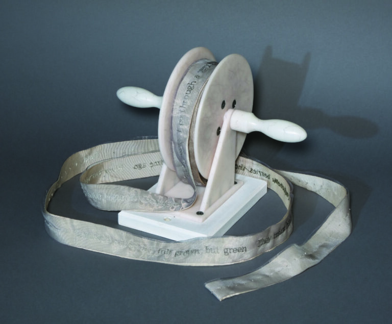 Kathy Kuehn (Portland, OR), Field, 2003, Tuille, grosgrain ribbon on composite spindle by Tim Moore, with 2823 French knots; text by Henry David Thoreau, September 11, 1853, journal entry, ribbon: 1.5”w x 50’l; spindle: 8”h x 7”w x 12”d, unique, photo by Hunter Stroud