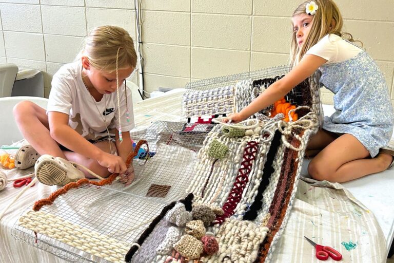 Campers work on a collaborative weaving project during Summer Art Camp. Ohio Craft Museum
