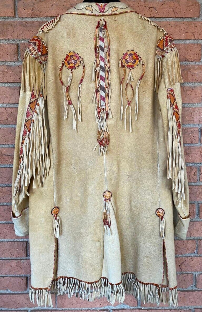 Detail of "Quilled Jacket with Shirt and Trousers" by Joe Savage, Porcupine quills, trade beads, buckskin, sinew, basswood bark fibers, natural dyes, brass button bases, woven, stitched, edged, sewn, ric rac quillwork. Joe Savage