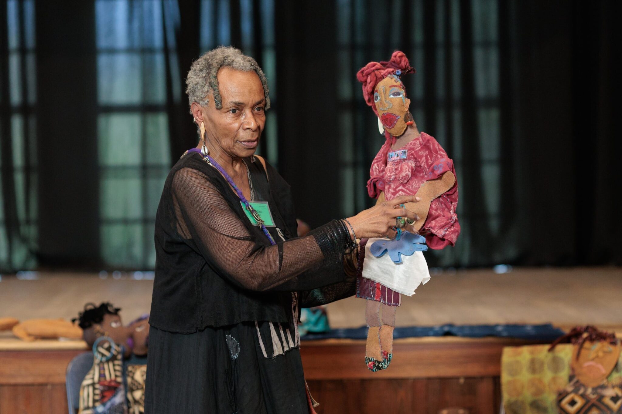 Doll and mixed media Textile artist Francine Haskins presents one of her dolls at Bridging Communities Through Craft events at John C. Campbell Folk School in Brasstown, NC, April 16-19, 2025. Photography by Chris Aluka Berry/ AlukaStorytellingPhotography.com Copyright Chris Aluka Berry