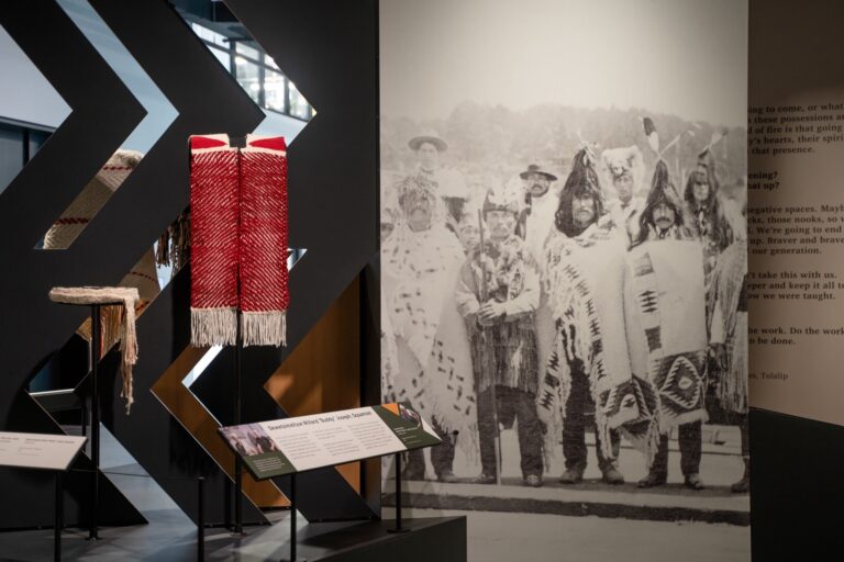Shown left, Ceremonial Belt, 2025, teeweewas Tillie Jones (Tulalip) and Chiefly Tunic, 2025, Skwetsimeltxw Willard “Buddy” Joseph (Squamish) featured in the Weaving Gallery. Chris Snyder/Burke Museum Shown left, Ceremonial Belt, 2025, teeweewas Tillie Jones (Tulalip) and Chiefly Tunic, 2025, Skwetsimeltxw Willard “Buddy” Joseph (Squamish) featured in the Weaving Gallery. Chris Snyder/Burke Museum