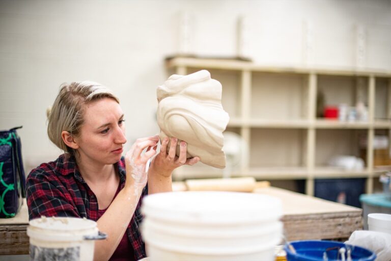 Student smoothing a hand-built ceramic form. TN Tech Photographic Services