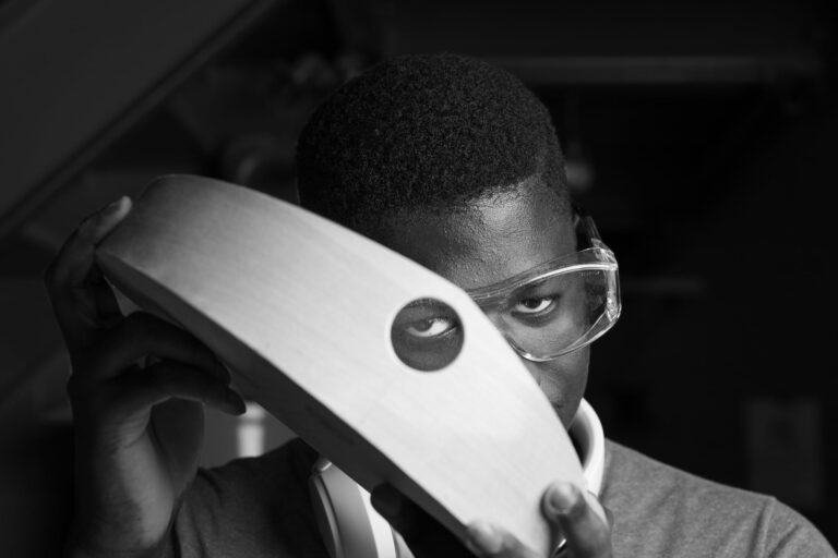 Student Muhamed '26 leads the production of our wooden dustpans. Now a senior Muhamed was randomly assigned a position in the woodshop as a first year and has seen his skills grow every year. Not only is Muhamed an accomplished maker but he has demonstrated at some of the countries finest museums. Sean Hall '25 and Evy Medley '25