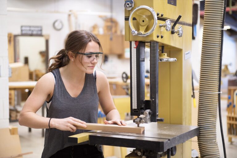 Student cutting wood on one of the wood studio's bandsaws. TN Tech University Photographic Services