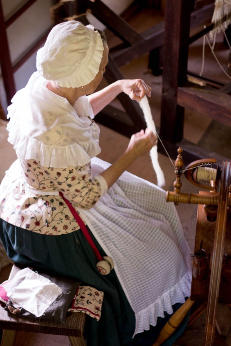 Spinning the site's heritage breed sheep wool. Colonial Farmstead