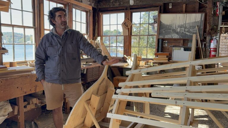 Graham McKay, Executive Director of Lowell's Boat Shop, speaking at the stern of our big project of 2025–2026, a 38' Bantry Bay Gig for Atlantic Challenge USA. We are a working museum, continuing to build new traditional plank-on-frame boats for clients. Anne Bryant, righthandanne.com