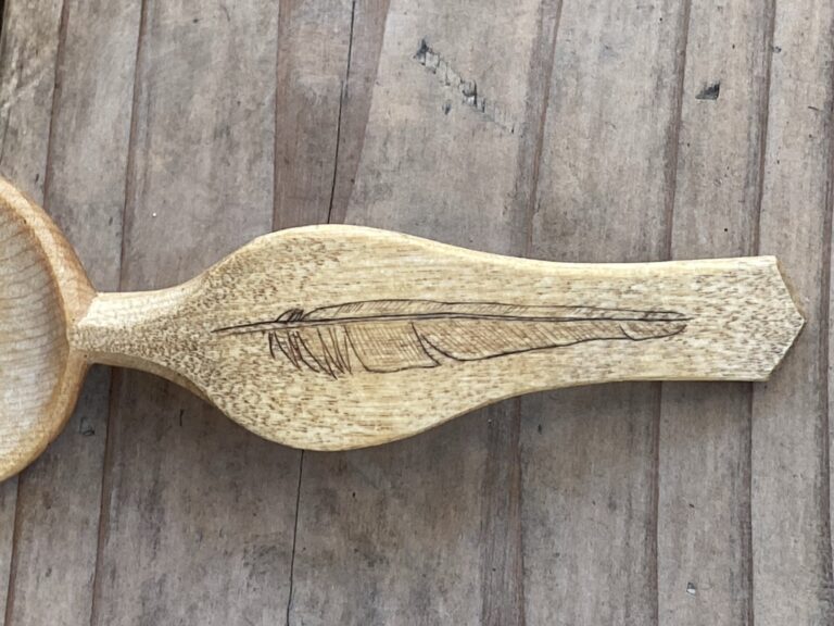 Spoon handle with the image of a feather carved into the handle. American Swedish Institute Spoon handle with the image of a feather carved into the handle. American Swedish Institute