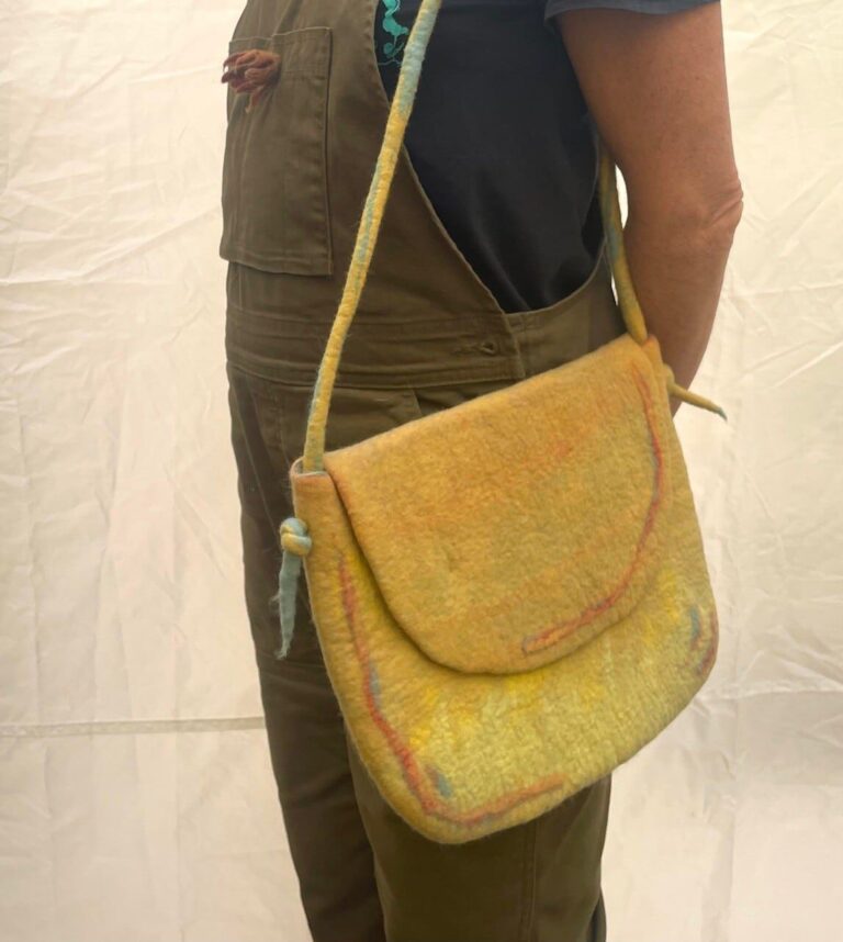 Wet felted shoulder bag worn around the sholder. American Swedish Institute