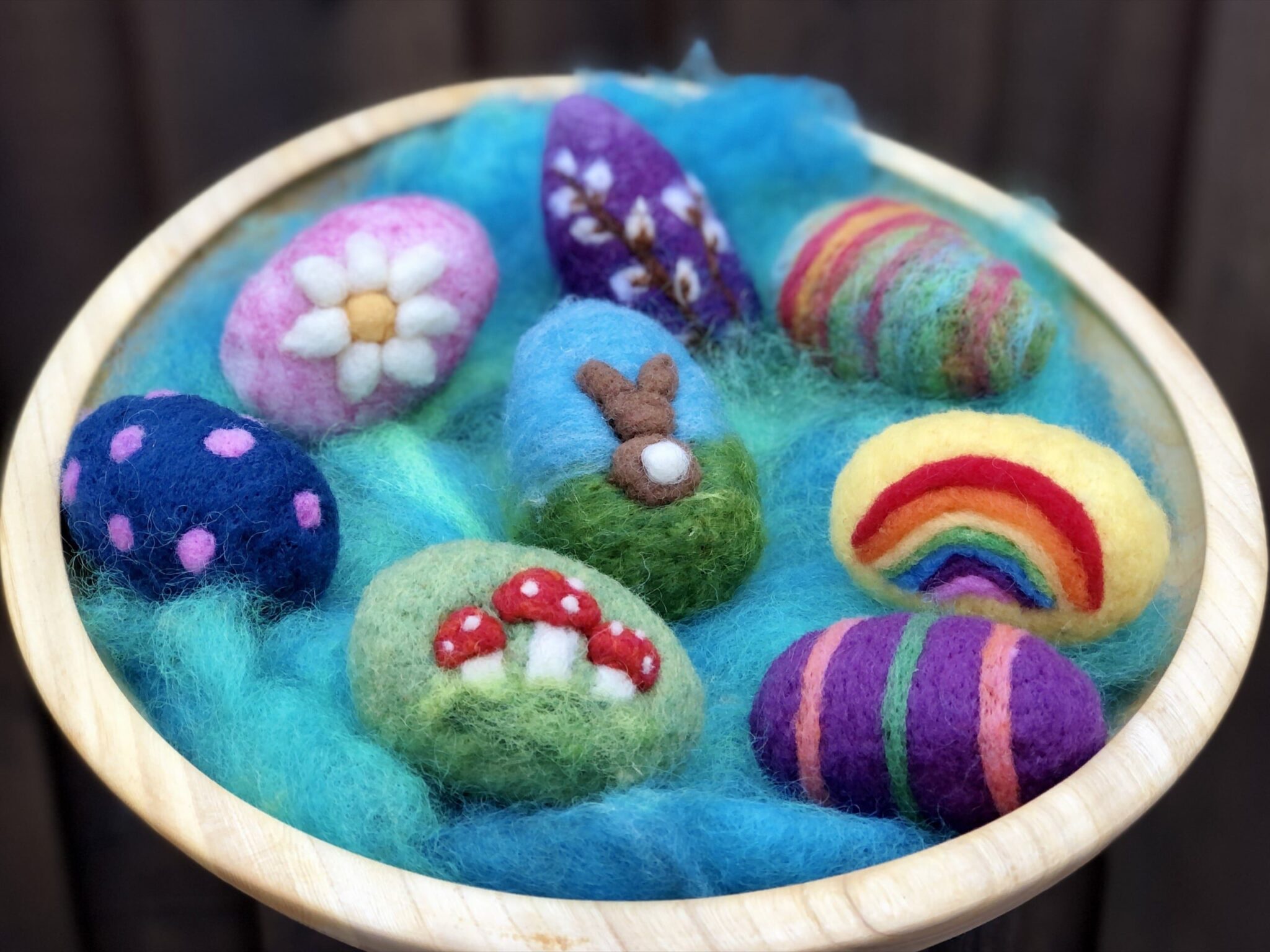 Small basket containing needle felted easter eggs. American Swedish Institute