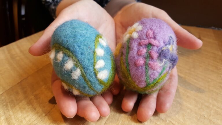 Felted easter eggs featuring pussy willows held in hands. American Swedish Institute