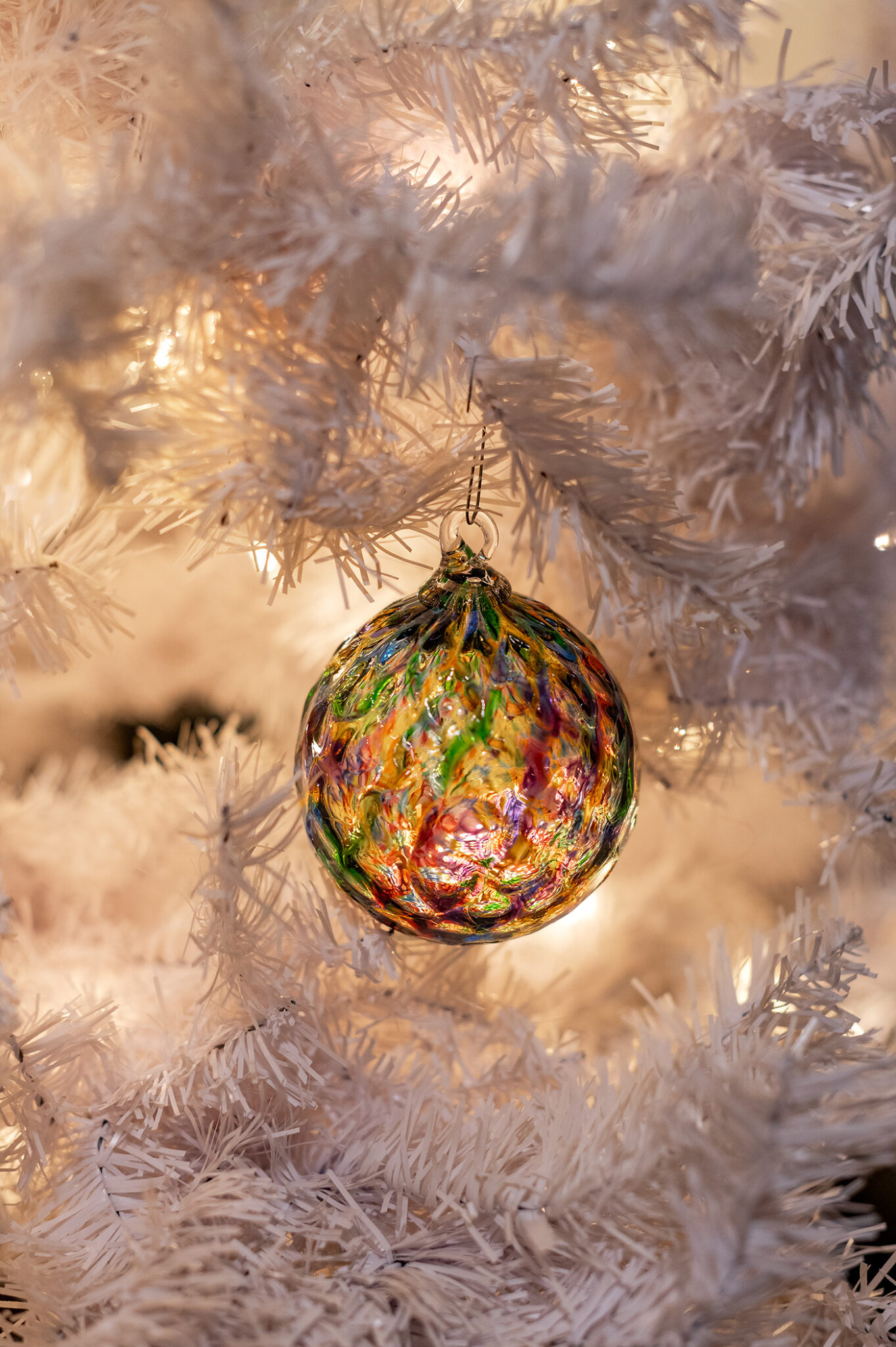 Hand blown glass ornament on flocked tree. Pilchuck Glass School