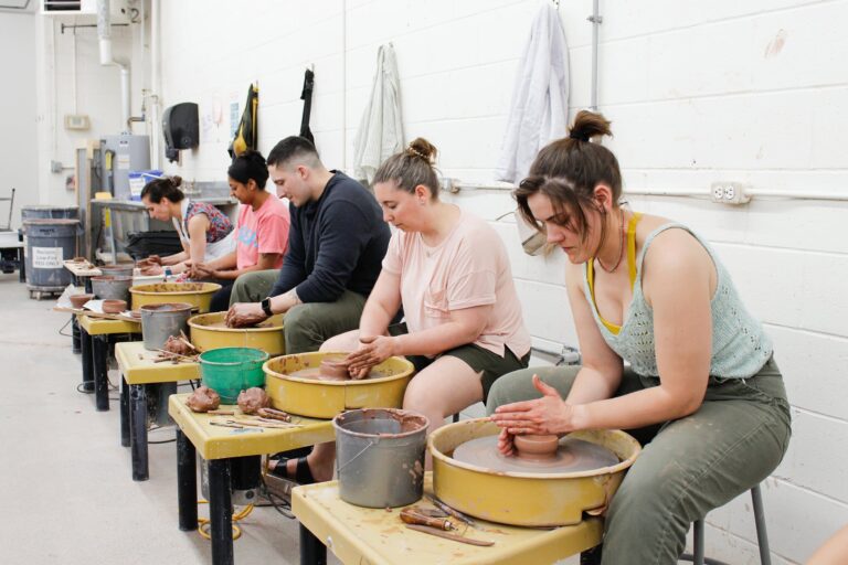 Students take a wheel throwing class though Northern Clay Center's Education Program
