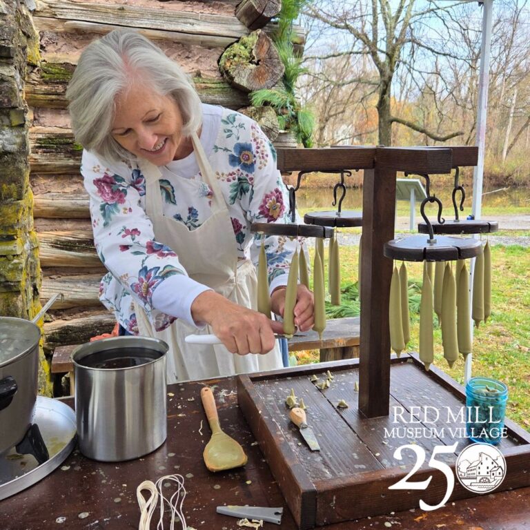 Red Mill Education Team Member demonstrating candlemaking. Red Mill Museum Village Red Mill Education Team Member demonstrating candlemaking. Red Mill Museum Village