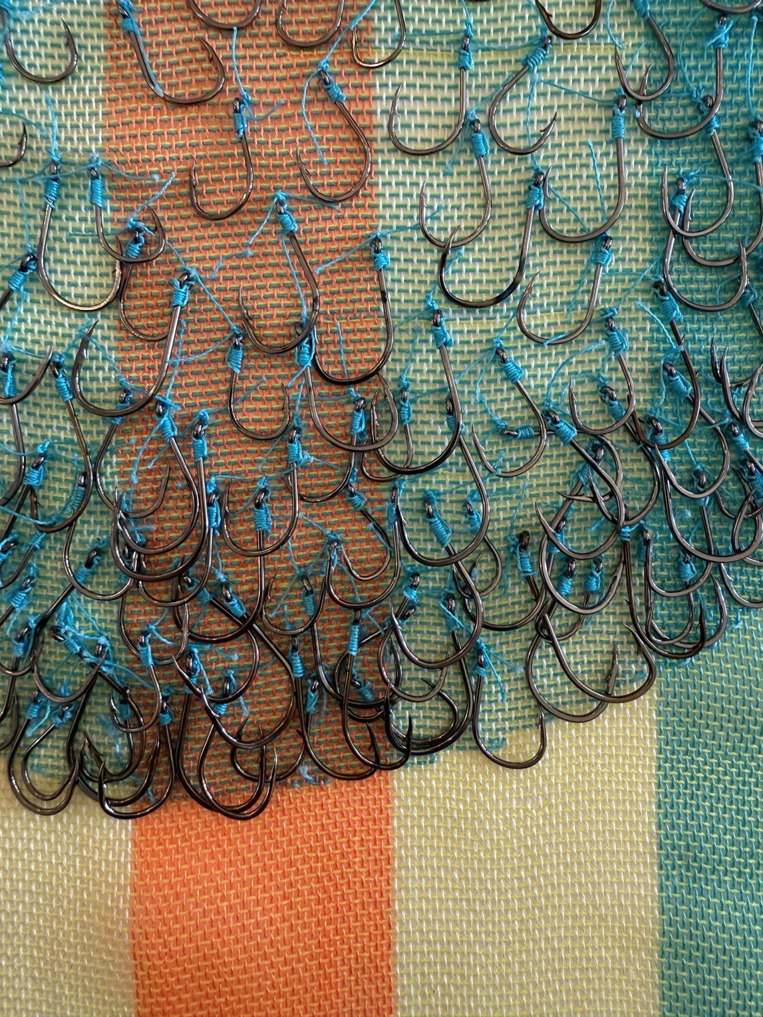 Ann Morton, Hook, Line and Sinker, Series of 3, 2025, Hand woven fishing line - braided; Jen Blazina, Recollection, 2007, 3D mixed media, 48 x 48 x 48 inches. fishing hooks; fishing line - monofilament; fishing sinkers, 16 x 20 inches. Courtesy of the Artist