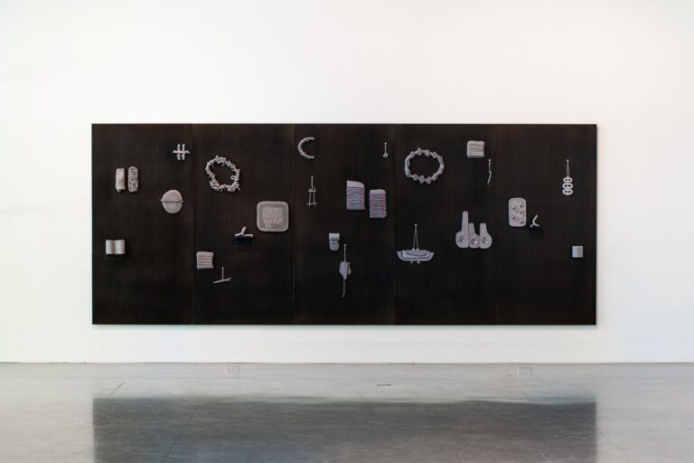 Mathew McConnell, “Didn’t Miss a Thing,” 2023. Dark stoneware on steel panels, 15 x 6 ft. Image provided by artist. Mathew McConnell, "Didn't Miss a Thing," 2023. Dark stoneware on steel panels, 15 x 6 ft. Image provided by artist.