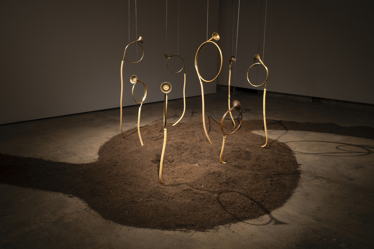 Listening, Breaking Down and Speaking Up, 2025 by Camila de Andrade Bianchi. Compost, bugle horns, suspension cables, 8-channel stochastic sound composition, Variable sizes. Photo Courtesy of the Artist
