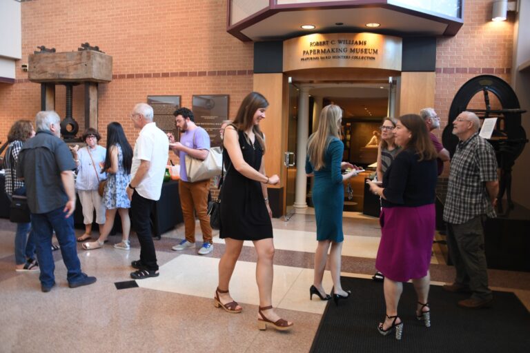 Many people are gathered in the lobby of the Paper Tricentennial Building for an exhibition reception Many people are gathered in the lobby of the Paper Tricentennial Building for an exhibition reception. RCW Paper Museum