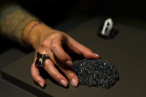 A hand holds a piece of jewelry by Lori Talcott from Jewels of the Underworld, presented by Sienna Patti at NYCJW25. Photo: Simon Leung